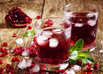 Fresh red juice cocktail with pomegranate seeds, mint and ice, s