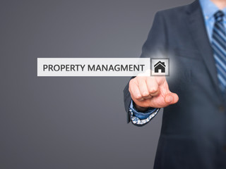 Businessman pressing property management button 