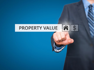 Businessman pressing Property Value button on virtual screen