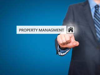 Businessman pressing property management button 