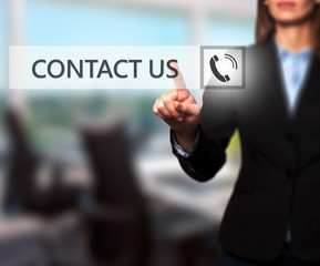 Businesswoman hand pressing contact us button