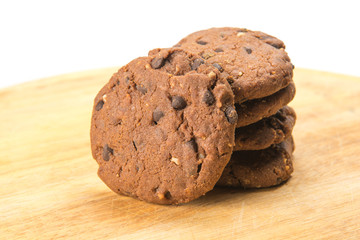 Homemade cookies with chocolate and hazelnuts on a wooden plate