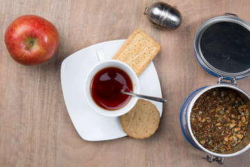 A morning breakfast with cake, apple and hot tea