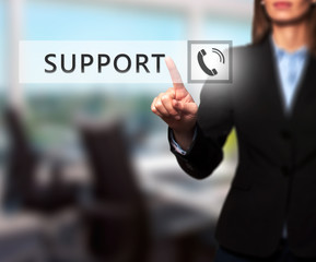 Fototapeta na wymiar Businesswoman pressing support button on virtual screen