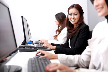 businesswoman smiling and looking at camera while working