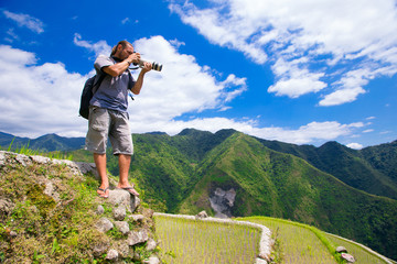 Fototapeta na wymiar A man photographs the landscape. Rice terraces in the Philippine