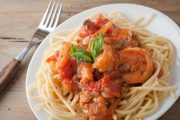 shrimp in wine tomato sauce over spaghetti pasta