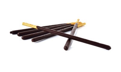 crackers stick and coated with black chocolate on white 
