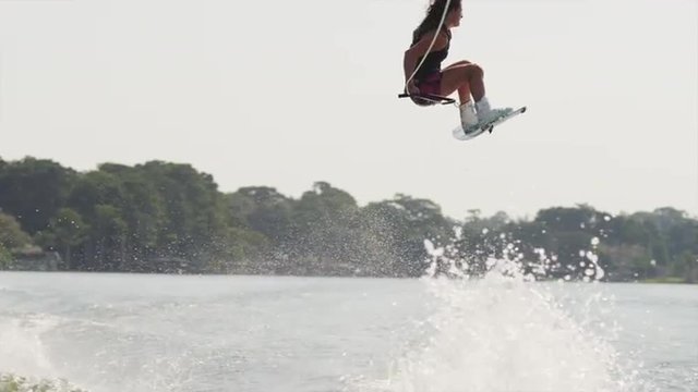 USA, Florida, Orlando, Maitland Lake, Woman jumping on wakeboard