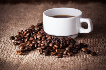 Coffee cup on coffee beans