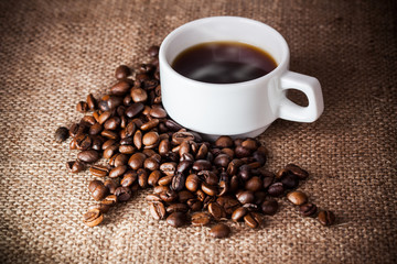 Coffee cup on coffee beans
