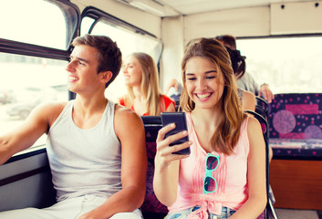 smiling couple with smartphone making selfie