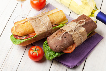 Two sandwiches and white wine