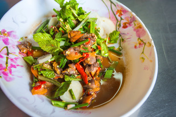 Spicy cockle salad with fresh vegetable on dish.
