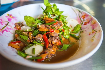 Spicy cockle salad with fresh vegetable on dish.