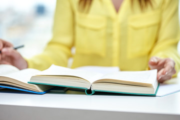 close up of female hands to book or textbook