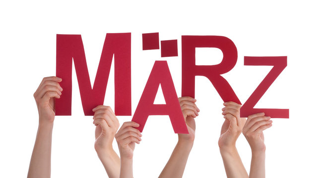 People Holding German Word Maerz Means March