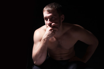 Fototapeta premium Image of shirtless man keeping his hands by face