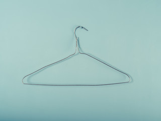 Wire hanger on a blue wall