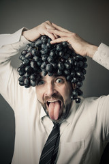 Crazy man portrait with grape on his head