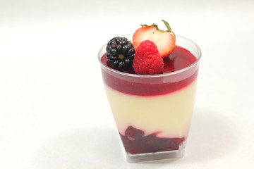 Fototapeta na wymiar dessert glass cup with fruits and chocolate mousse