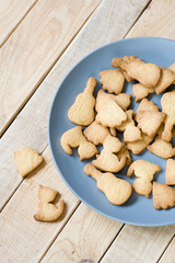 Grey plate with tasty cookies in the form of figurines of cats