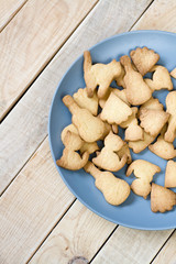 Grey plate with tasty cookies in the form of figurines of cats