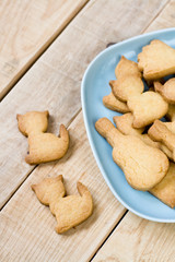 Blue plate with tasty cookies in the form of figurines of cats