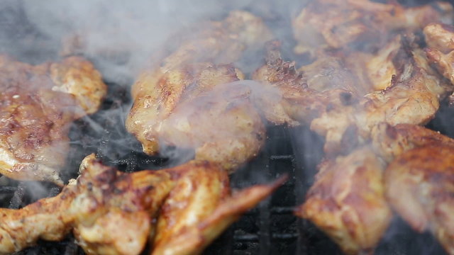 Chicken meat on barbecue grill - zooming in 