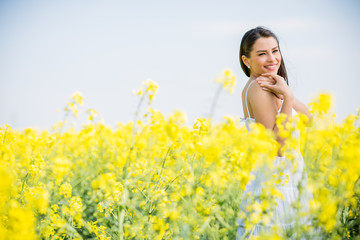 Fototapeta premium Young woman in the spring field