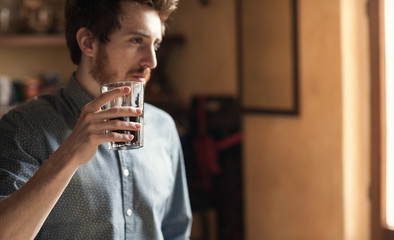 Hipster man drinking a glass of coke