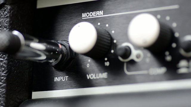 Inserting a Cable into a Guitar Amp