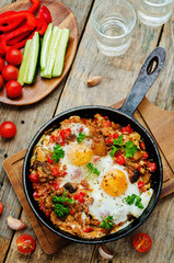 fried eggs with peppers, tomatoes, quinoa and mushrooms