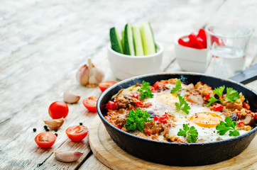 fried eggs with peppers, tomatoes, quinoa and mushrooms