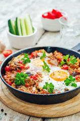 fried eggs with peppers, tomatoes, quinoa and mushrooms