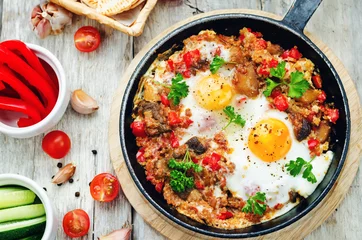 Wall murals Fried eggs fried eggs with peppers, tomatoes, quinoa and mushrooms