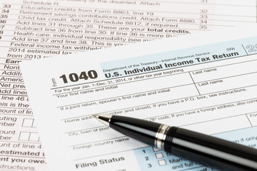 Tax form with pen taxation concept