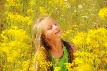 Naklejka na ściany i meble Portrait of happy girl in summer field