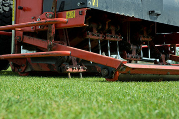 Tractor aerating a football field.