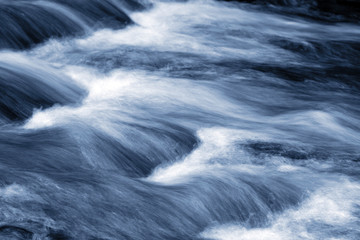 Blue stream water flowing