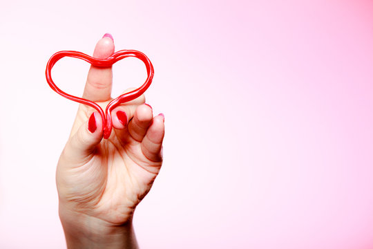 Female hahd holding red heart love symbol. Valentines day.