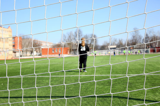 Image of a goalkeeper through the net