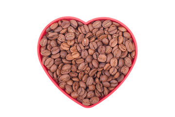 Coffee beans in a dish in the shape of a heart.