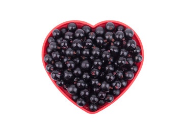 Currants in a dish in the shape of a heart.