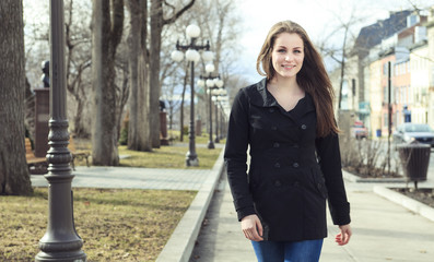 Portrait of beautiful brunette girl walking