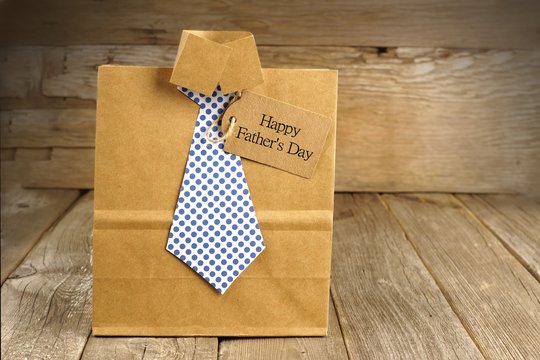 Fathers Day shirt and tie gift bag on a wood background