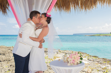 Couple getting marriage on the tropical caribbean beach.