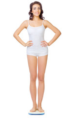 Obraz premium Young healthy girl on home scales
