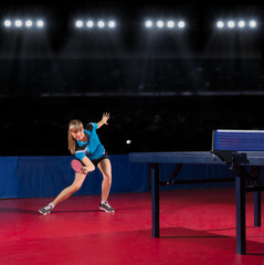 Girl table tennis player at sports hall