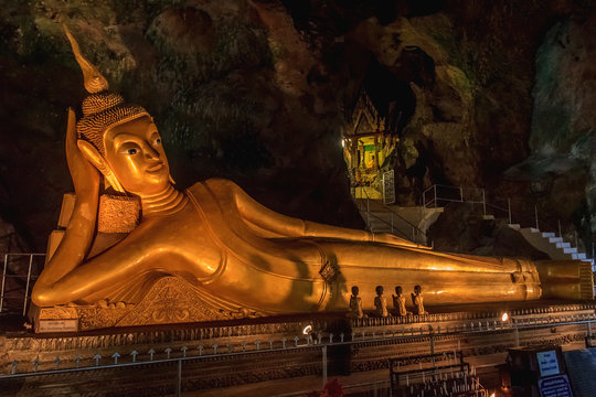 Statue of Reclining Buddha in a cave temple in Thailand